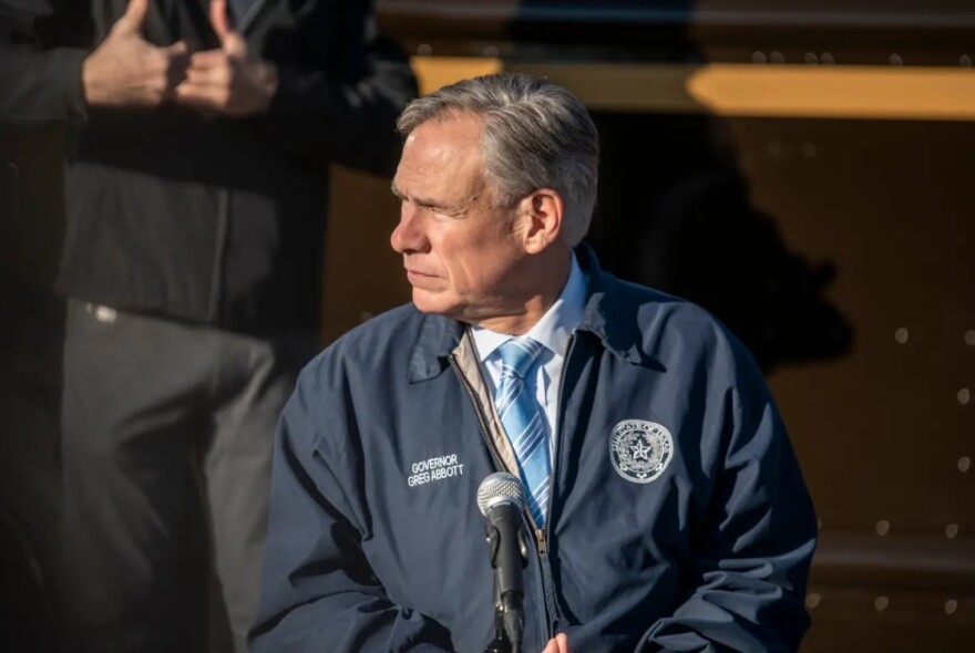 Gov. Greg Abbott listens at a press conference in Austin on Dec. 17. 