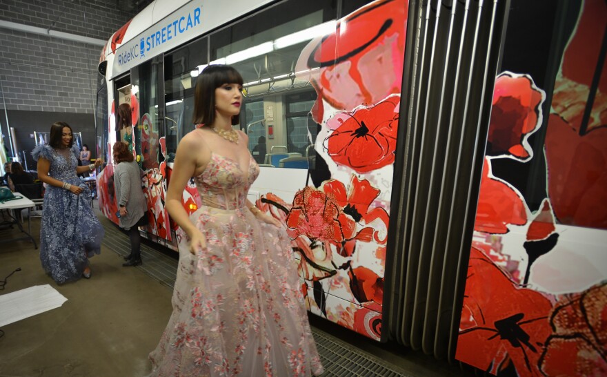 Models Jocelyn Dale, left, and Shelby Ratner head to the rear of a RideKC streetcar in early October where they would rehearse their catwalk for the upcoming Coalesce fashion show.