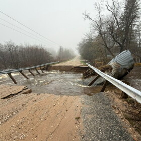 Storm damage to Johnson Road in Kaleva after rain-swollen Bear Creek twisted massive culverts and swept away the bridge. (Photo: Charlie Brooks / for the Northern Michigan Journalism Collaborative)