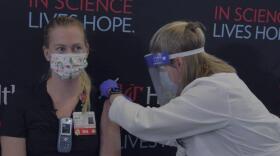 Katie Walz, RN, in the cardiovascular ICU at UC Medical Center, was the first recipient at UC of Pfizer's COVID vaccine.