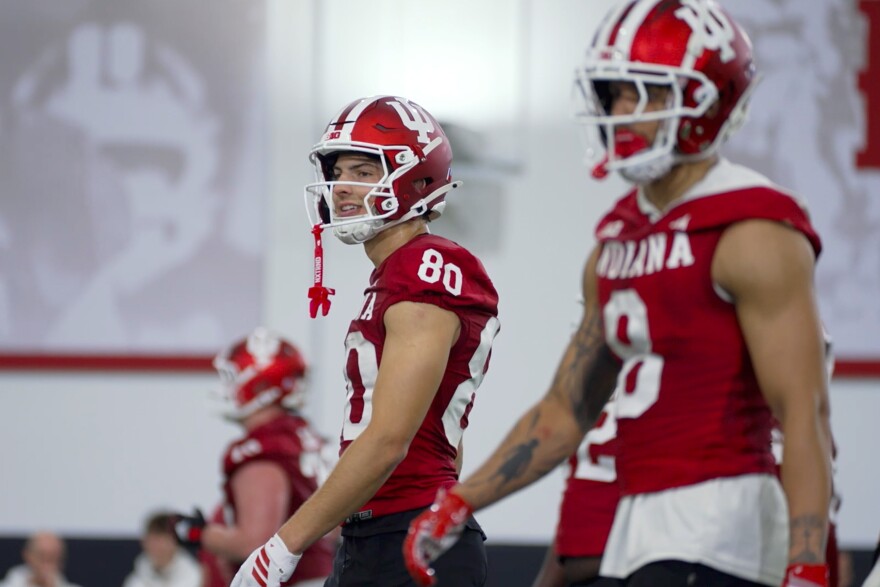 Indiana wide receivers Charlie Becker (left) and Nick Marsh walk the field during the first day of spring football practice Thursday.