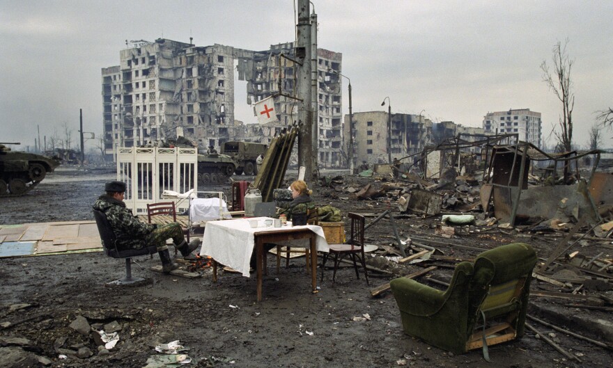 Russian soldiers rest in Chechnya's capital, Grozny, in February 2000. Russia waged two wars against Chechnya from 1994 to 2000. In both wars, Russia heavily bombed Chechnya, flattening Grozny and causing tens of thousands of civilian deaths. [Dmitry Belyakov / Associated Press]