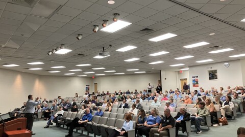 Members of the audience listen during a hearing on hospital expansion at A-B Tech's Ferguson Auditorium Wednesday, August 19, 2026.