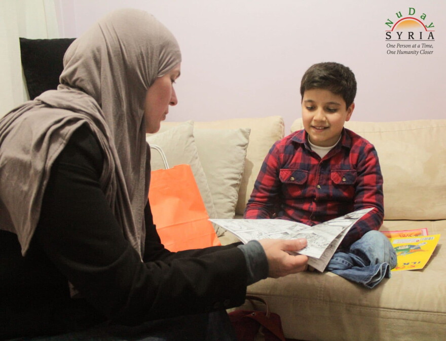A Syrian refugee child reads the free comic book at a refugee camp in Turkey. (Courtesy NuDay Syria)