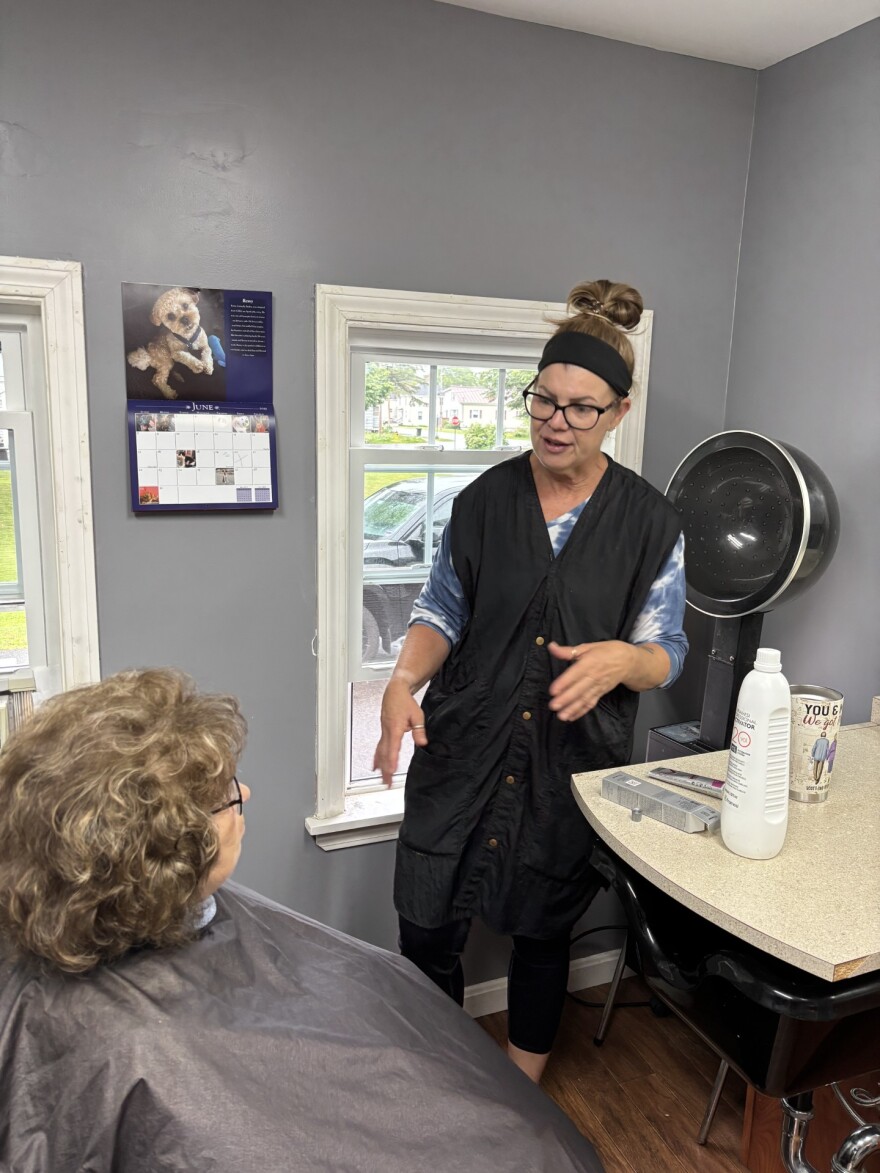 Stephanie Boardman-Wallace talks to a client in her salon.
