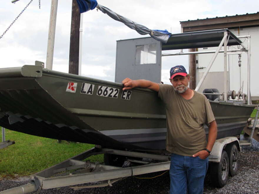 Al Cassagne, who lives just outside of Grand Isle, La., has been fishing the local waters for more than 32 years. He is standing next to one of three commercial fishing boats he operated until the oil spill closed off the fishing waters.