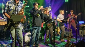 Afrobeatniks performing live with percussion, horns, and guitar.