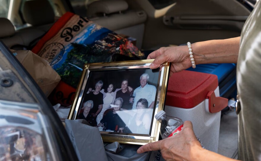 Lisa Sethmann show some of the personal items she gathered when she evacuated from her home in Friend, Ore.