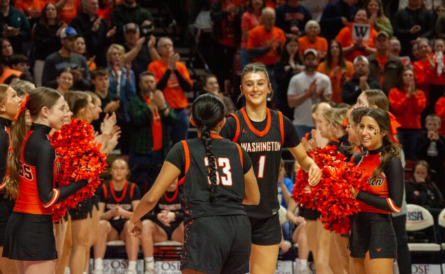 Girls high school basketball players inside an arena