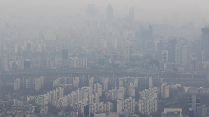 Buildings are seen shrouded in smog from the 102nd floor of Seoul's Lotte World Tower in December 2015.