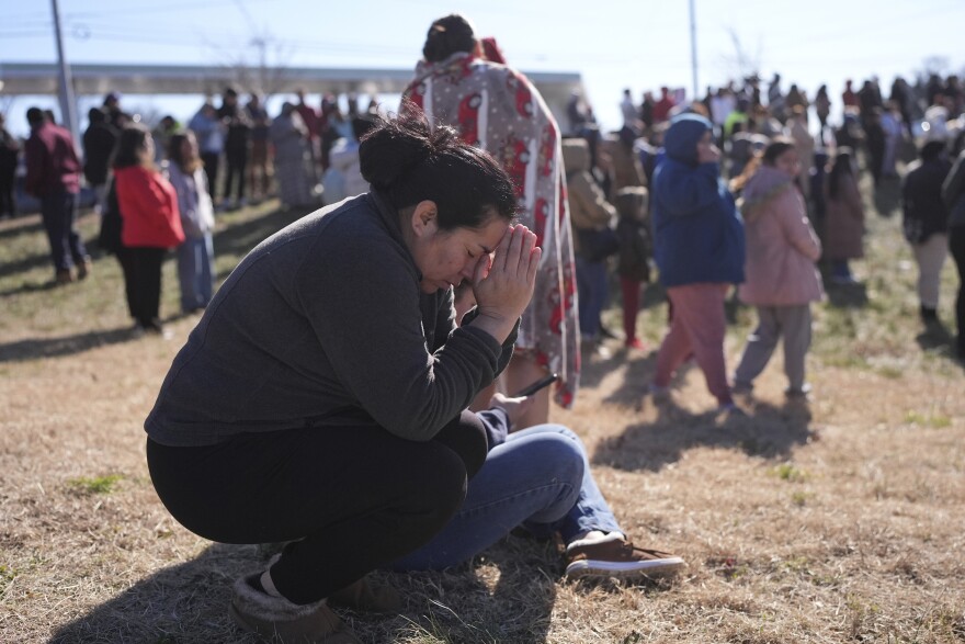 Dasia Pleitez prays as she waits for her daughter at a unification site following a shooting at the Antioch High School in Nashville, Tenn., Wednesday, Jan. 22, 2025.