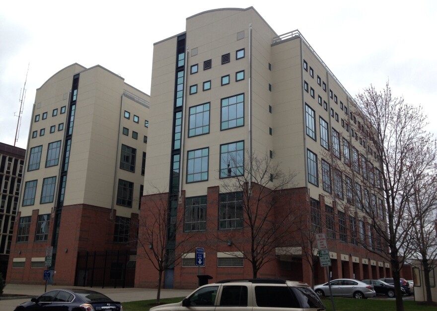 A beige and brick six story building.