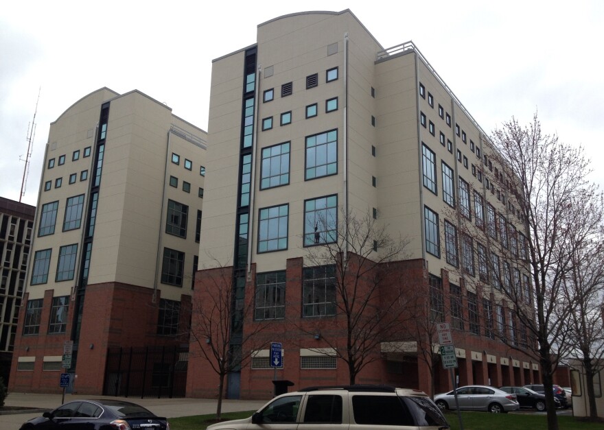 Two several-story buildings stand next to each other. 