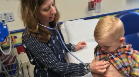 Children's Mercy Hospital nurse practitioner Jodi Shroba gives Porter Hall a checkup before a peanut allergen exposure session. 