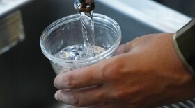 FILE - A cup of water is drawn from a faucet.