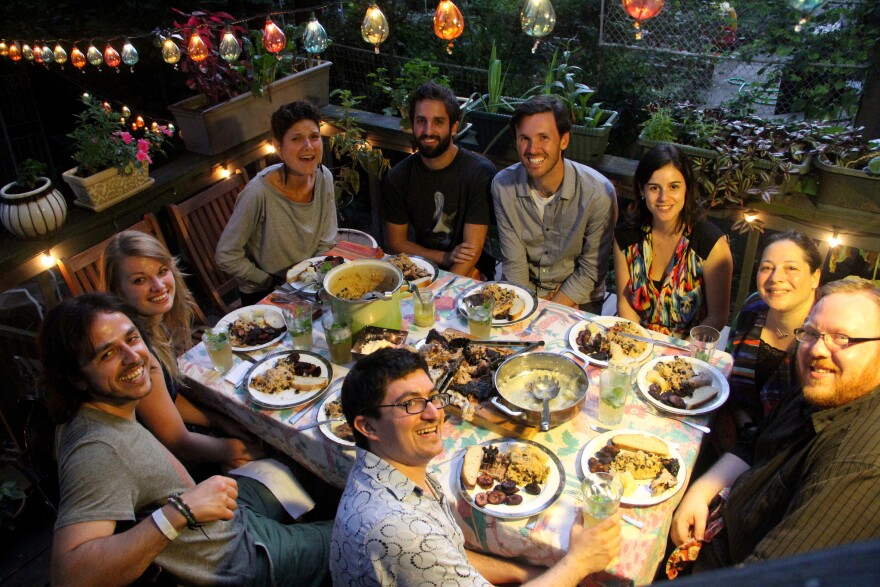 Jesse Friedman (center, foreground) and guests dine outdoors during Cuba night, Aug. 26, 2012.