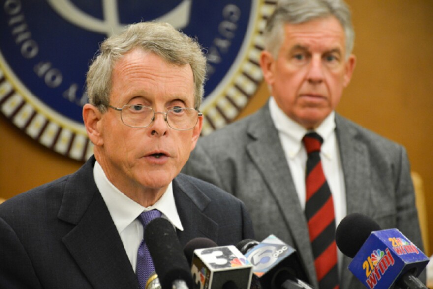 Ohio Attorney General Mike DeWine, flanked by Cuyahoga County Prosecutor Tim McGinty, at a 2014 news conference. (Nick Castele / ideastream)