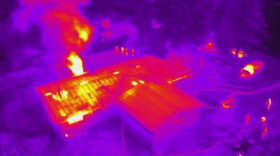 The view from a UAV's thermal imaging camera, above the scene of a house fire. (Courtesy via KQED)