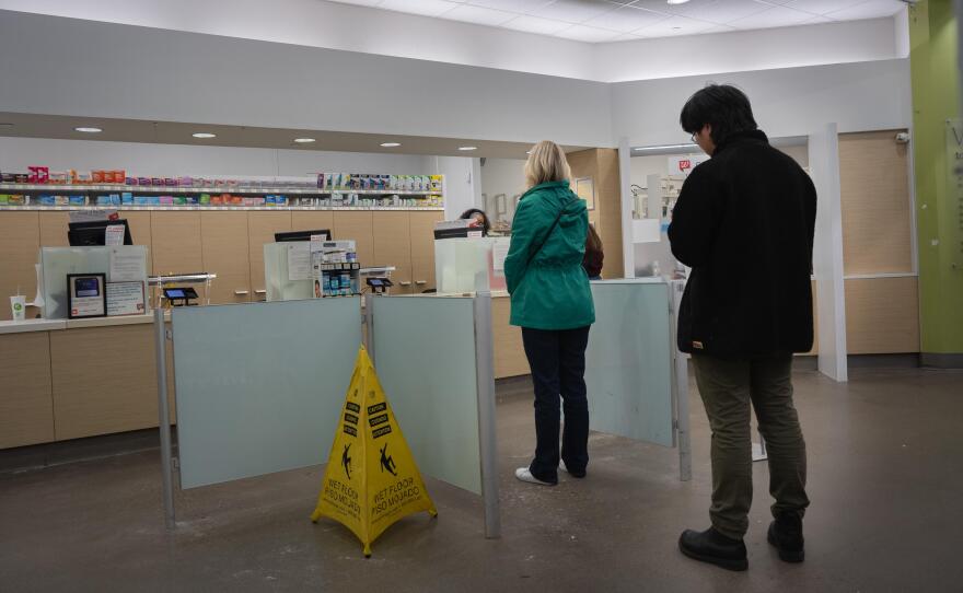 People wait in line at a Walgreens pharmacy in Roseville on Thursday, March 26, 2026.