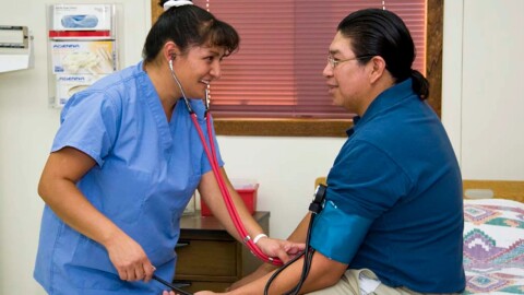 A medical assistant takes the vitals of the patient