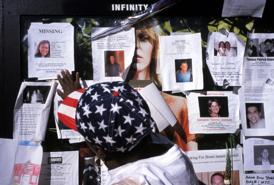 Families and friends leave photos of missing people outside Saint Vincent's Hospital on Sept. 15, 2001.