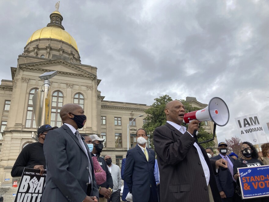 FILE - African Methodist Episcopal Church Bishop Reginald Jackson announces a boycott of Coca-Cola Co. products outside the Georgia Capitol on March 25, 2021 in Atlanta. The Supreme Court decision ordering Alabama to redraw its congressional maps is a surprise victory for Black and Latino voters across the country who say legislatures in a number of Republican-controlled states have drawn districts in a way that dilutes their political strength. (AP Photo/Jeff Amy, File)