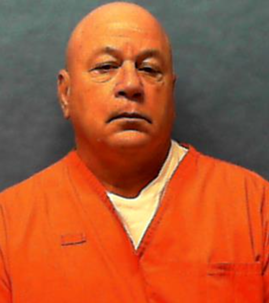 Bald man in orange jumpsuit 