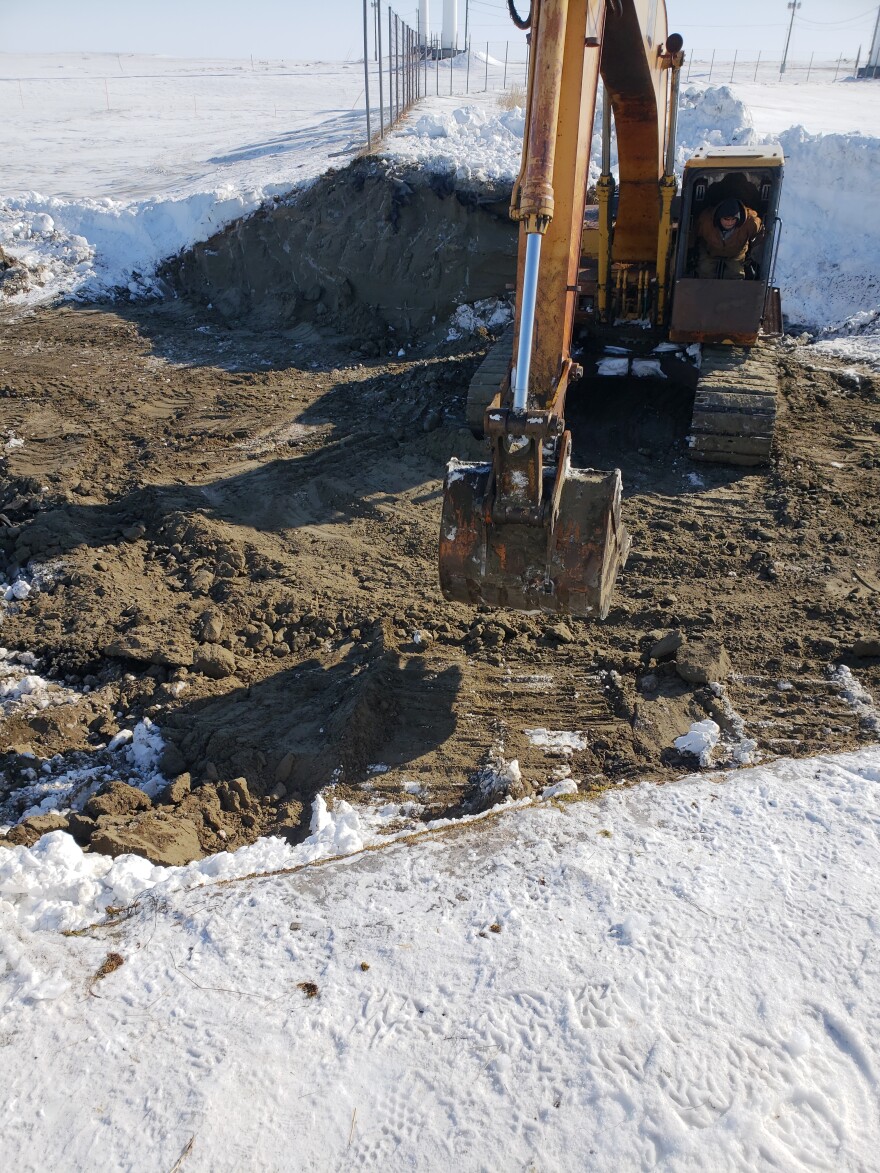 Hooper Bay workers have partially filled the hole in the community's sewer lagoon, stopping the flow of sewage onto the surrounding tundra.