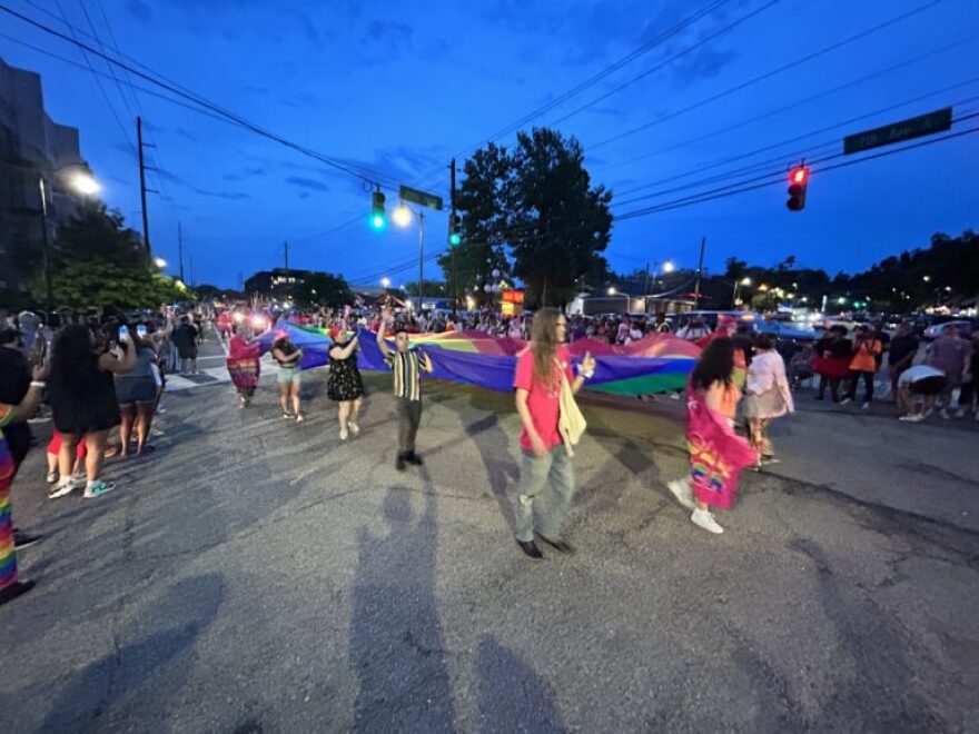 Parade marchers carried a large Pride flag down 7th Avenue in Birmingham.