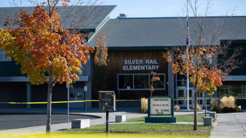 Police caution tape surrounds Silver Rail Elementary in Bend, Ore., Friday, Oct. 16, 2026, a day after a deadly shooting.