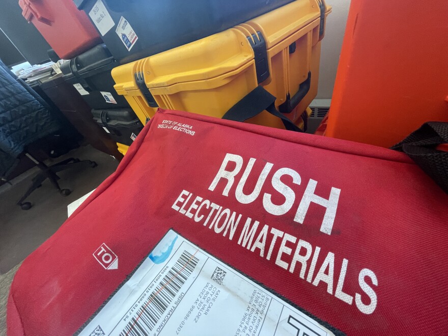 Boxes and crates in a room. One says "election materials"