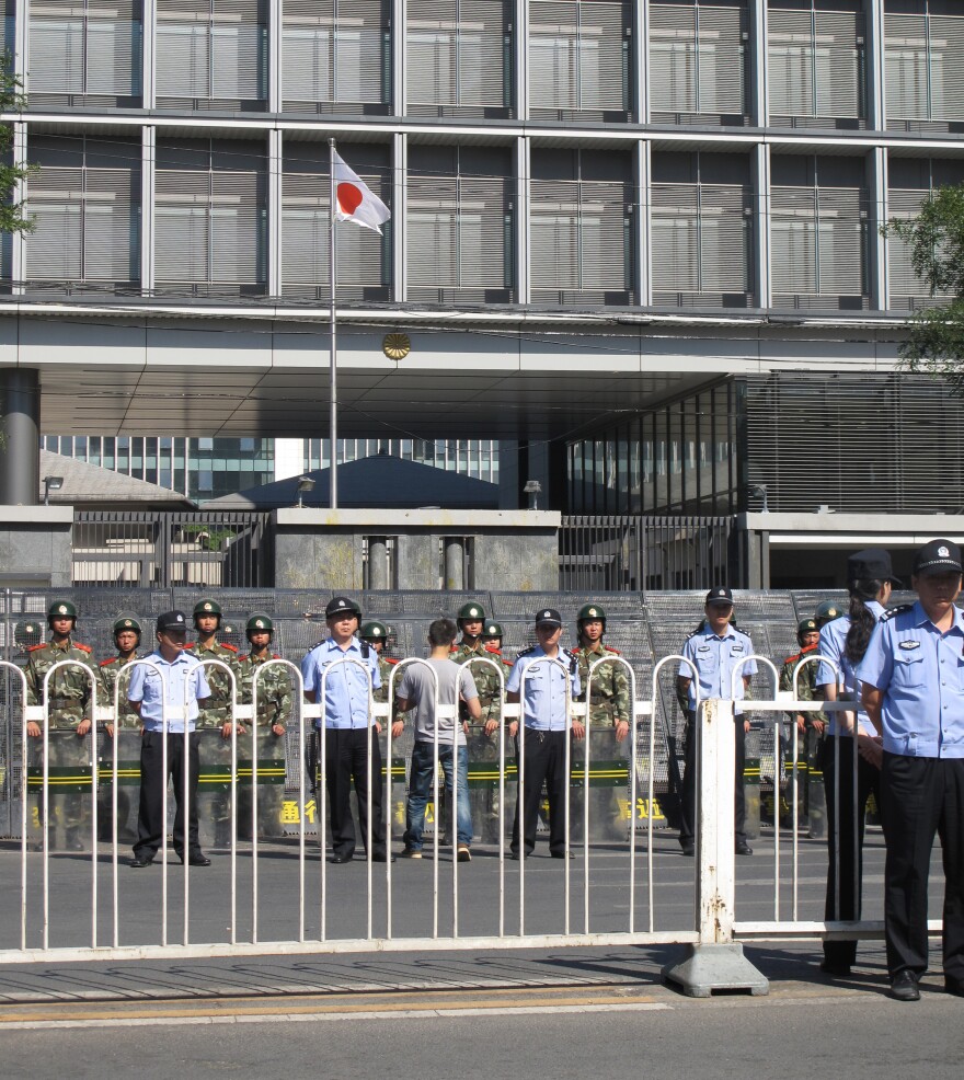 The Japanese flag flies in front of the embassy, whose walls were yolk-stained after being pelted with eggs during weekend protests.