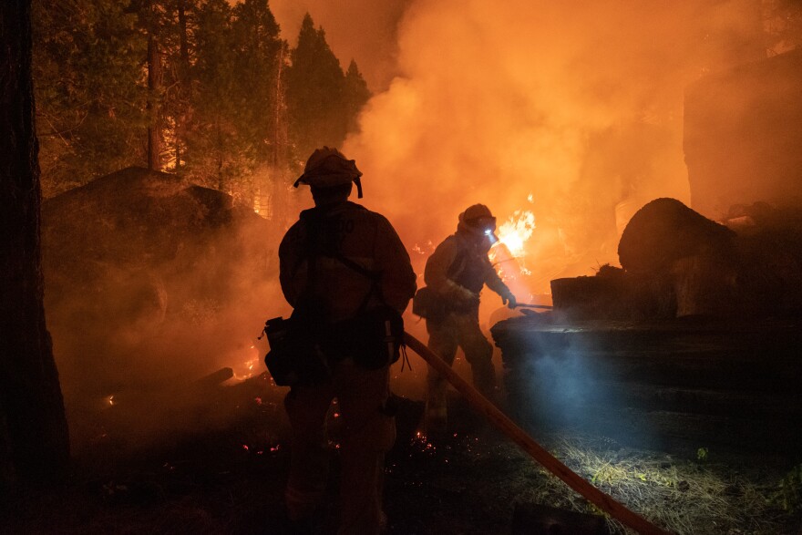 Firefighers protect homes in Christmas Valley from the Caldor Fire Monday, Aug. 30, 2021. Andrew Nixon / CapRadio