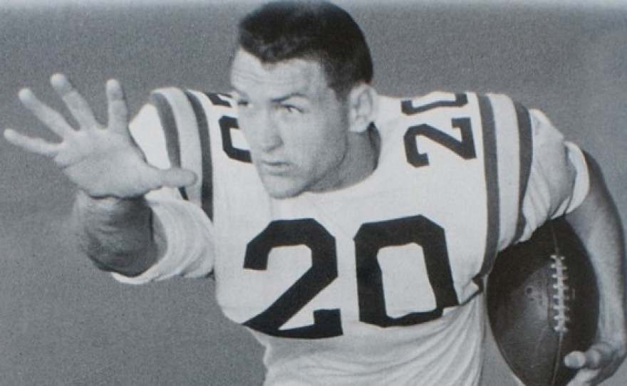 This image is a photo of Billy Cannon that was originally released in a press packet by Louisiana State University (LSU) to promote their football team. It is used in a Wikipedia article about him to demonstrate how he looked while playing football for LSU