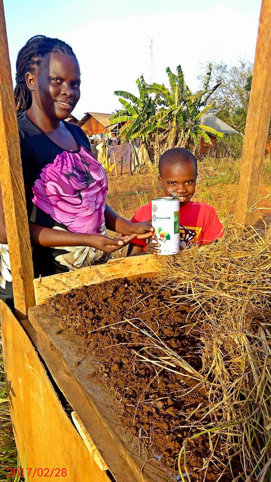 Faith and her son, William, are ready to plant some coriander seeds.