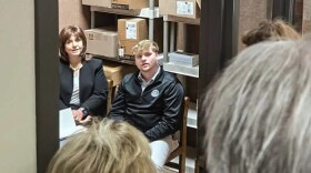 Assistants to US Rep. Mark Messmer are seated in a small meeting room at the Warrick County Public Library, Tuesday March 11. Standing outside are constituents who want to speak to them as a group, in a larger room. The library offered a conference room when the crowd grew to more than 10 waiting to speak to them. An out-of-state Messmer staff member reportedly phoned the library, requesting they call the police.