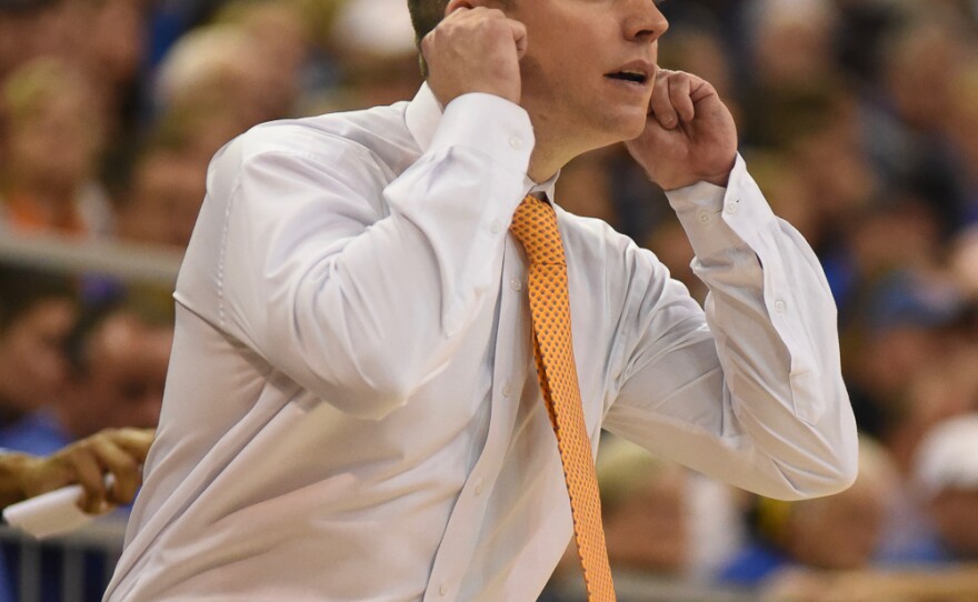 When unsure about a foul in the first half, Florida coach Michael White signals the official in attempt to get clarification. (Greenberry Taylor/WUFT News)