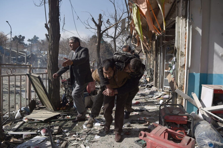 Afghan volunteers carry a body at the scene of a car bomb exploded in front of the old Ministry of Interior building in Kabul on Jan. 27, 2018.
An ambulance packed with explosives blew up in a crowded area of Kabul on January 27, killing at least 17 people and wounding 110 others, officials said, in an attack claimed by the Taliban. (Wakil Kohsar/AFP/Getty Images)