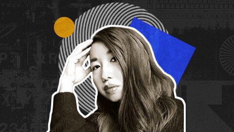 Muriel Leung sits with her head resting on her hand, in front of colorful cutouts