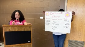 Justine Crespo (left), 16, presents her community service project on the final day of Take the Mic's week-long program at Springfield Technical Community College.