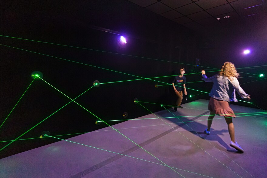 The Light Lab exhibit at Science City includes a laser maze where visitors can enter a tunnel and navigate a web of lasers, then press a button that will add even more.
