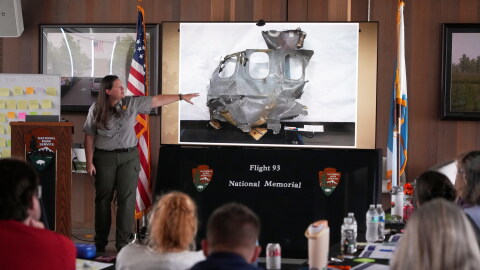 U.S. Park Ranger Betsy Keene, curator of National Parks of Western Pennsylvania, explains a slide showing a damaged part of United Flight 93 during an educators seminar at the Flight 93 National Memorial in Shanksville, Pa., Tuesday, June 23, 2026.