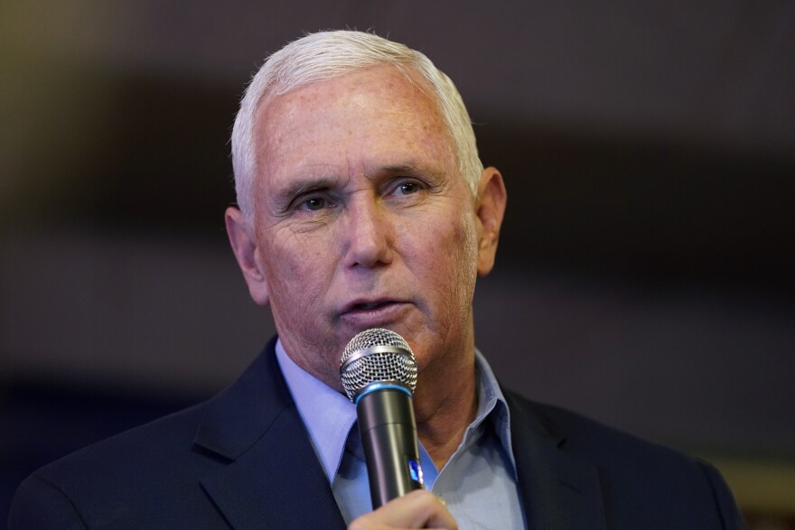 a close up of mike pence holding a microphone