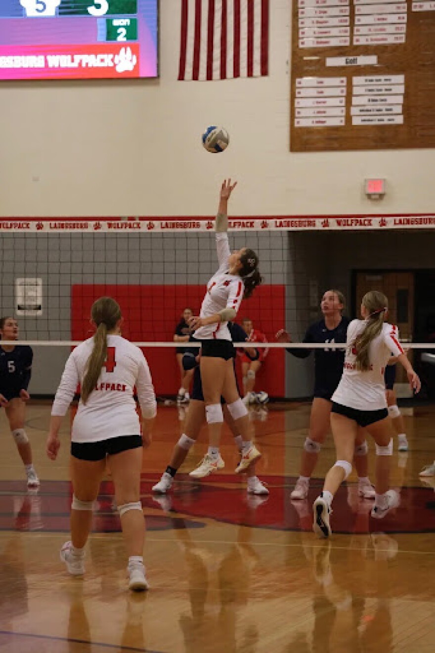 Kendall Michels reaching for the ball to set for her teammate.