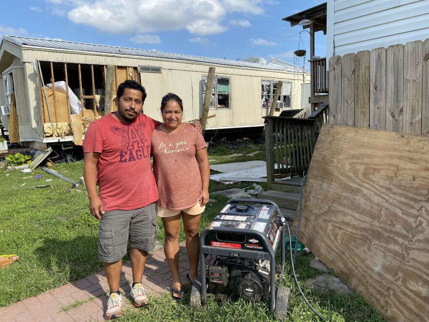 Ivan Velazquez and Leydi Lopez's home mostly held together during the hurricane. The roof is in tatters and some of the siding is damaged. But they've got a generator and they're neighbors are staying with them. Ten people in all as they make repairs.