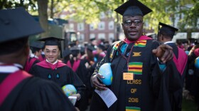 Gregory "Buster" Coleman in his cap and gown. Each graduate of the Kennedy School of Government carried an inflatable globe.