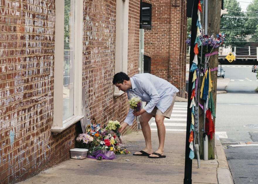 Peter Reijmers, 29, of Charlottesville, lays flowers at a memorial on 4th Street SE where Heather Heyer was killed last August.