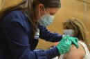 Certified registered nurse Raechel Blades gives Patricia Benavides, 55, her second dose of the Moderna vaccine on Monday, March 8 2021 at the Tony Aguirre Community Center.2