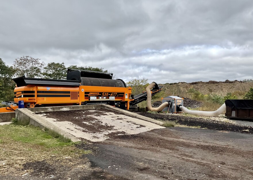 A large organge machine known as a trommel screen is used to sift finished compost.