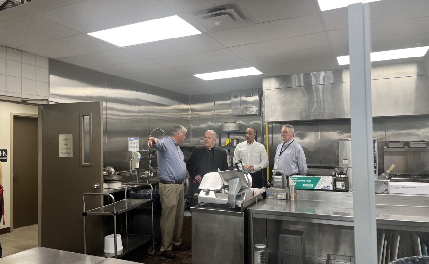 Rob Williams, executive director of the St. Francis of Assisi Kitchen, left; the Most Rev. Joseph Bambera, Bishop of Scranton; David Hollander, St. Francis of Assisi Kitchen board chairman; and Joe Mahoney, Diocesan Secretary for Catholic Human Services/Chief Executive Officer of Catholic Social Services, right, tour the meal center. 